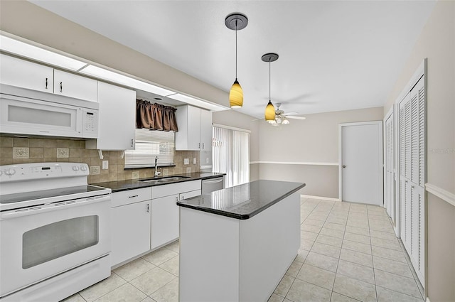 kitchen with light tile patterned floors, white appliances, backsplash, and a sink