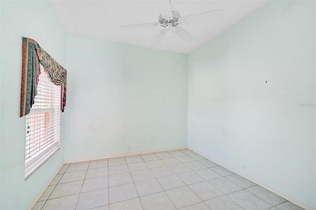 empty room with light tile patterned flooring and ceiling fan