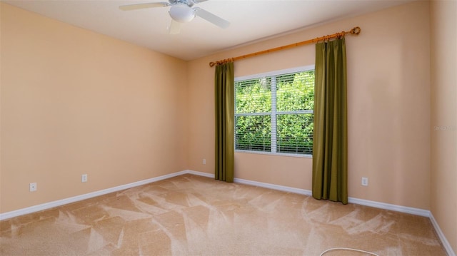 unfurnished room featuring light carpet, ceiling fan, and baseboards