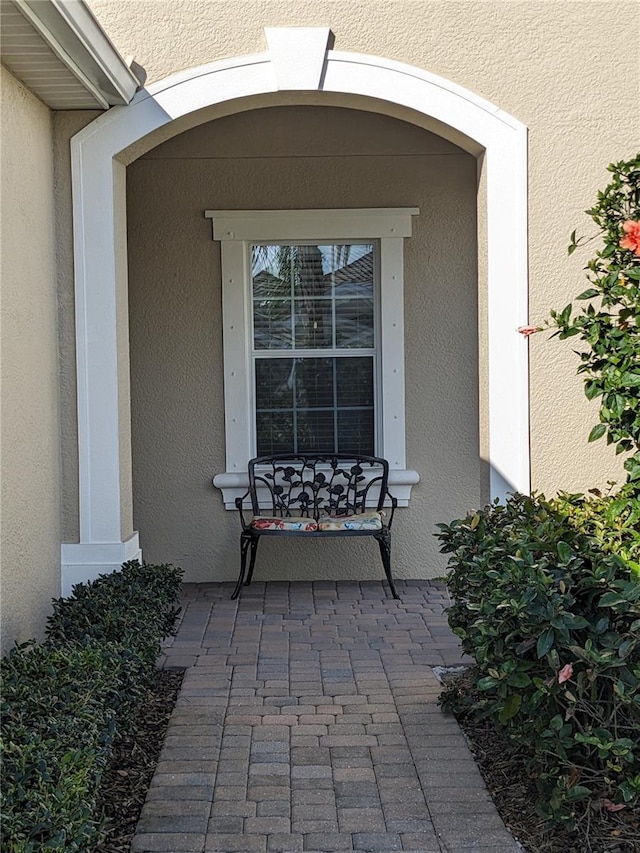 entrance to property with stucco siding