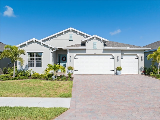 view of front of property with a garage and a front yard