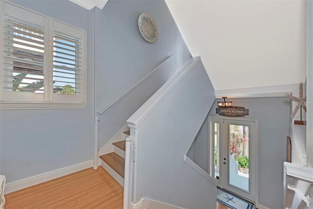 stairway with light hardwood / wood-style flooring and plenty of natural light