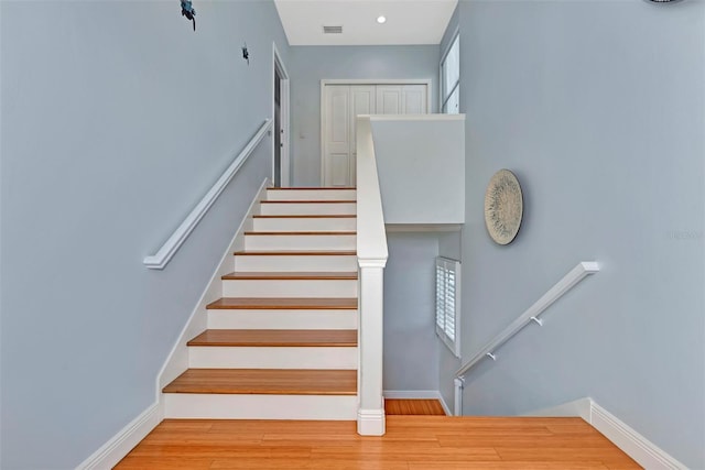 stairway featuring light wood-type flooring