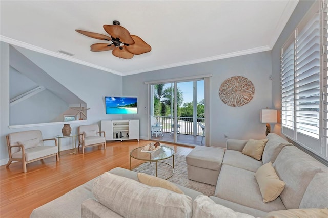 living room with ornamental molding, light hardwood / wood-style flooring, and ceiling fan