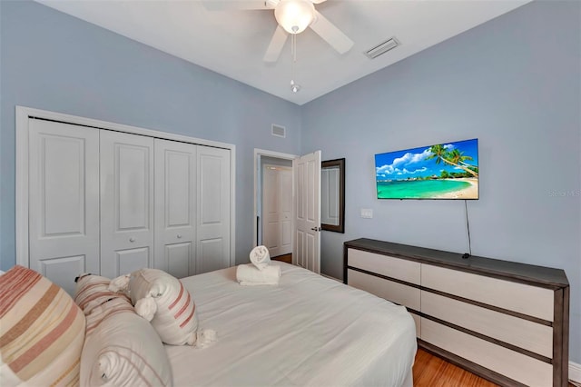 bedroom with ceiling fan, hardwood / wood-style flooring, and a closet