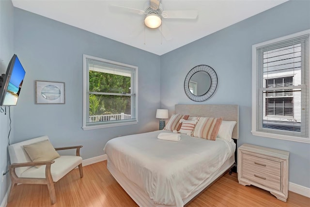 bedroom with light hardwood / wood-style flooring and ceiling fan