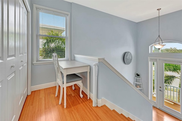 office area with light hardwood / wood-style flooring and a healthy amount of sunlight