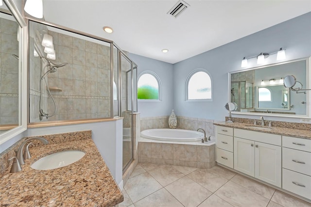 bathroom featuring tile patterned floors, plus walk in shower, and vanity