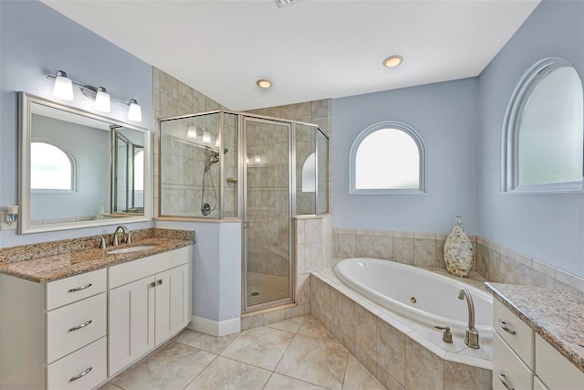 bathroom featuring plus walk in shower, vanity, and tile patterned floors