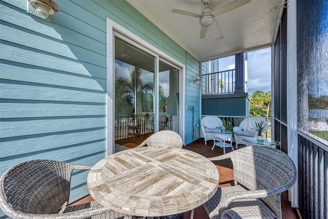 sunroom featuring ceiling fan