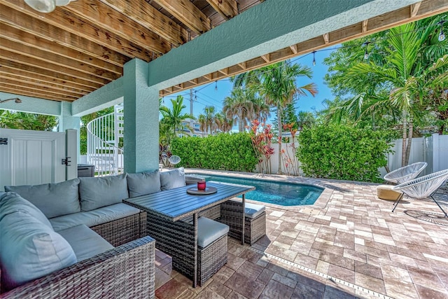 view of patio / terrace featuring an outdoor living space, ceiling fan, and a fenced in pool