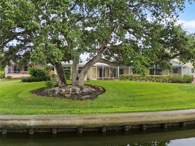 exterior space featuring a water view, a lanai, and a front yard