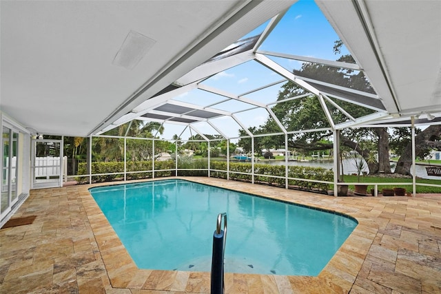 view of swimming pool with glass enclosure and a patio area