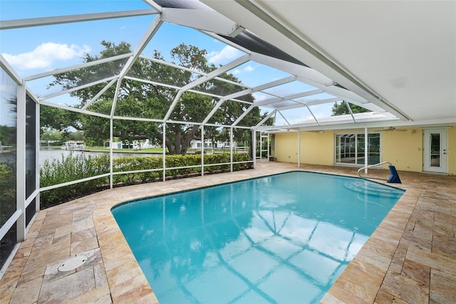 view of swimming pool with glass enclosure and a patio area