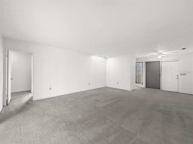 spare room with light colored carpet and ceiling fan