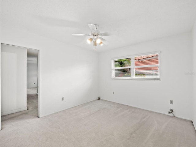 unfurnished room featuring ceiling fan and carpet floors