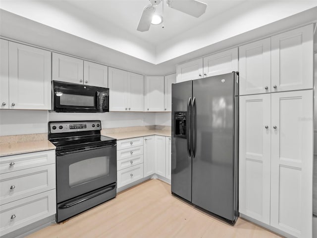 kitchen with ceiling fan, light hardwood / wood-style floors, white cabinets, and black appliances