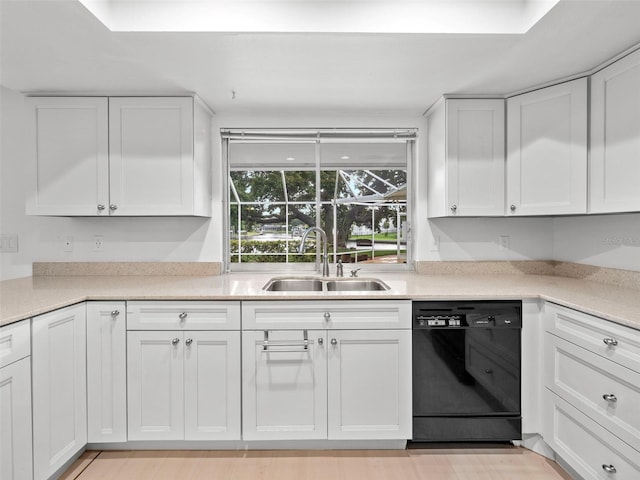 kitchen featuring light wood-type flooring, white cabinets, sink, and dishwasher