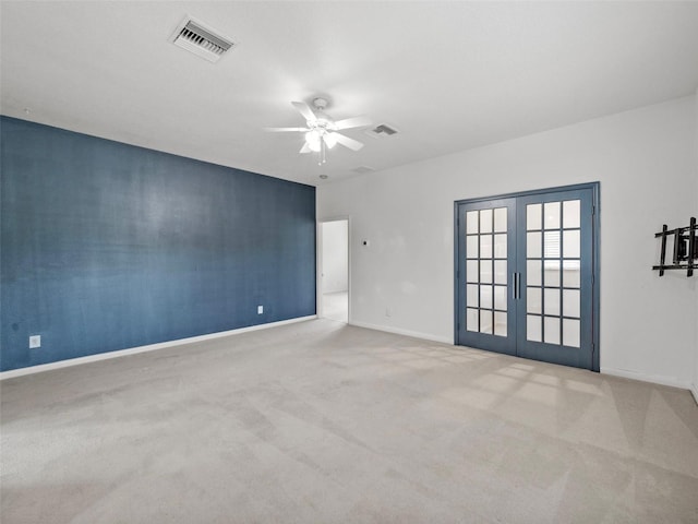 empty room with carpet floors, ceiling fan, and french doors