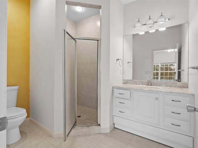 bathroom featuring tile patterned flooring, toilet, walk in shower, and vanity