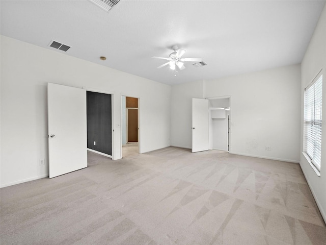 carpeted spare room with ceiling fan