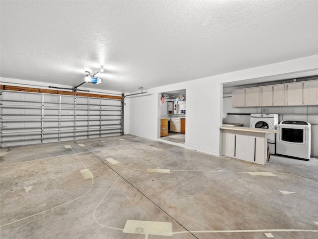 garage with washing machine and clothes dryer and a garage door opener