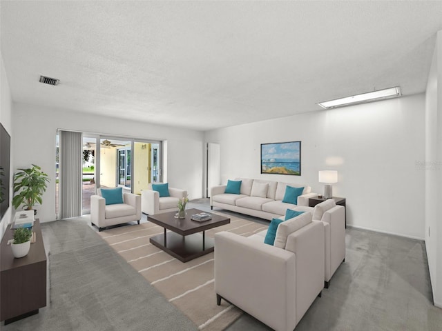 carpeted living room with a textured ceiling