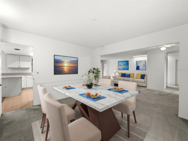 dining area with light colored carpet