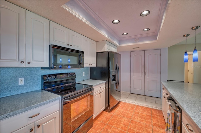 kitchen featuring a raised ceiling, black appliances, ornamental molding, white cabinetry, and tasteful backsplash