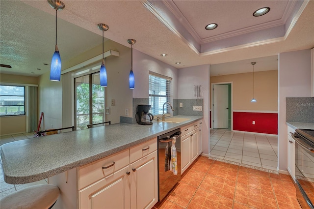 kitchen featuring dishwasher, tasteful backsplash, a tray ceiling, crown molding, and sink