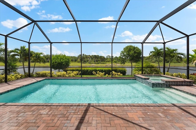 view of pool featuring an in ground hot tub, a lanai, and a patio