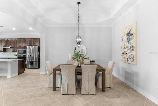 dining space with light tile patterned floors, a notable chandelier, ornamental molding, and a raised ceiling