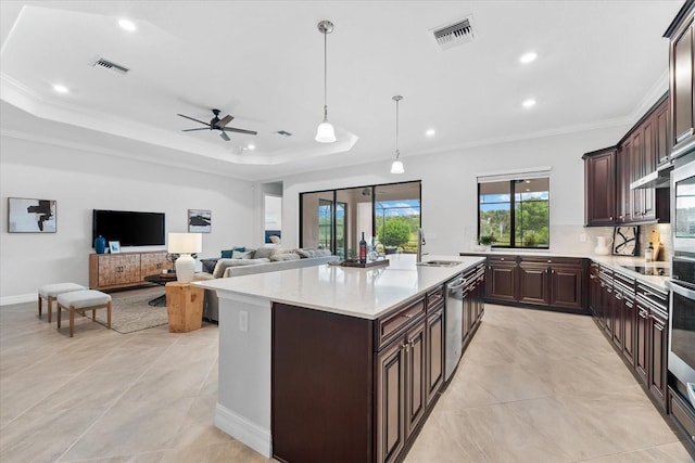 kitchen featuring pendant lighting, ornamental molding, a center island, and dark brown cabinets