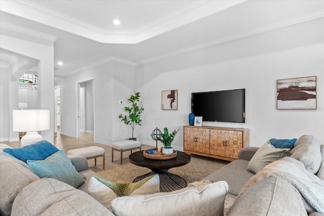 tiled living room featuring a raised ceiling and crown molding