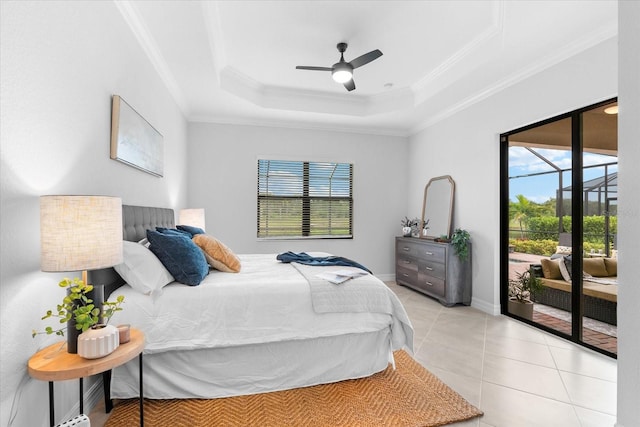 tiled bedroom with ornamental molding, access to exterior, ceiling fan, and a tray ceiling