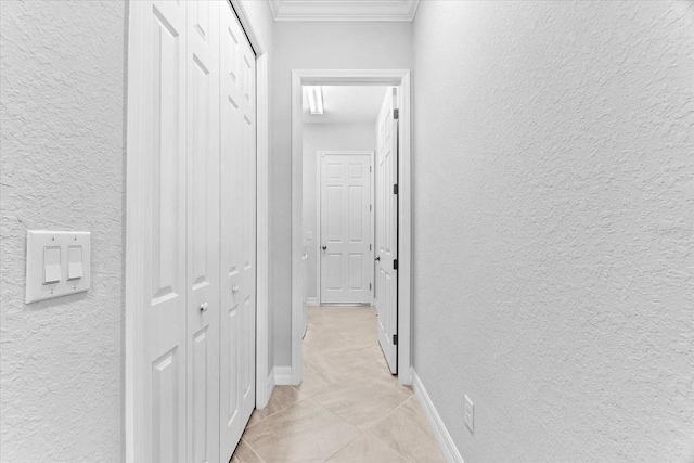 corridor featuring crown molding and light tile patterned flooring