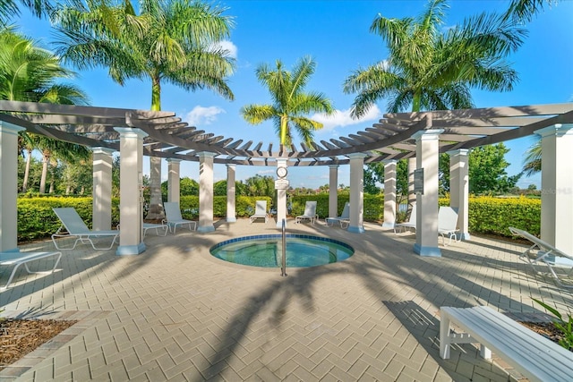 view of swimming pool with a community hot tub, a pergola, and a patio area