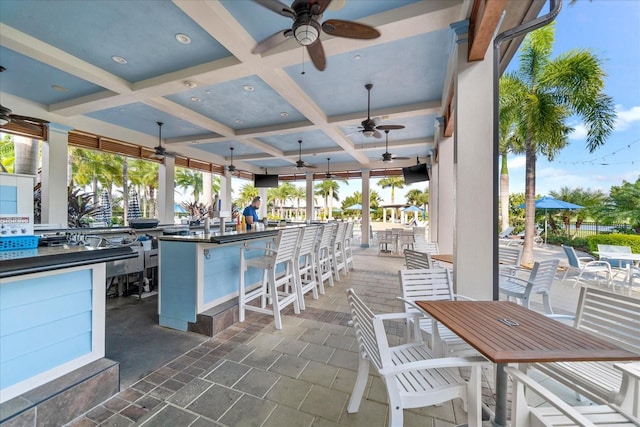 view of patio with an outdoor bar and ceiling fan