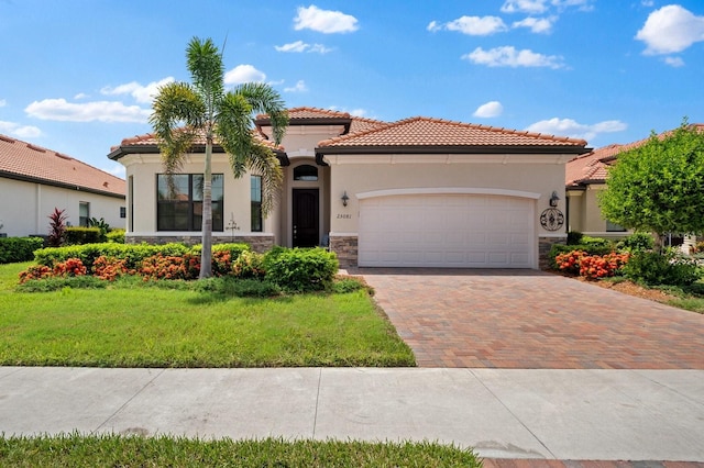 mediterranean / spanish-style house with a garage and a front lawn