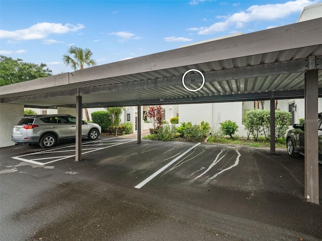 view of parking / parking lot featuring a carport