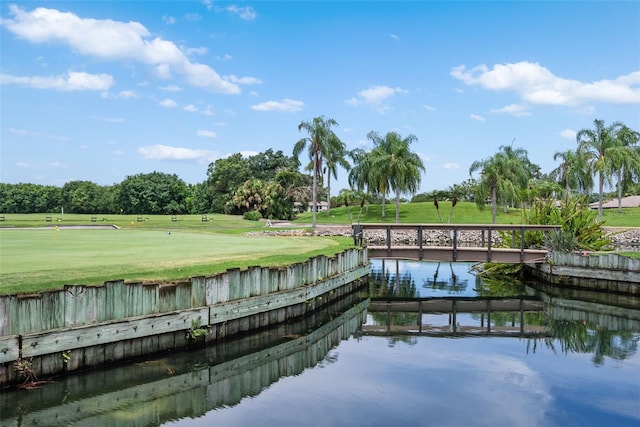 dock area featuring a water view and a lawn