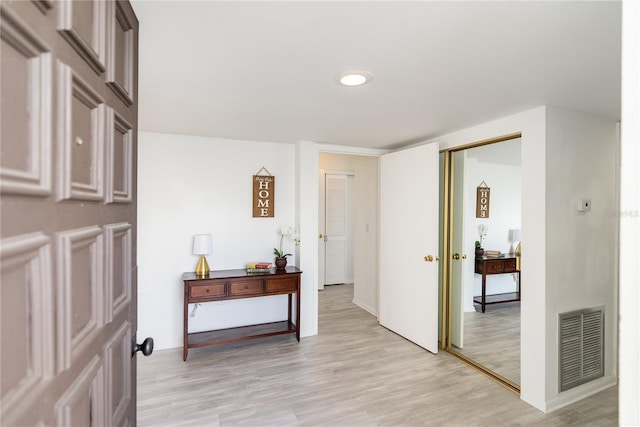 hall with light hardwood / wood-style flooring