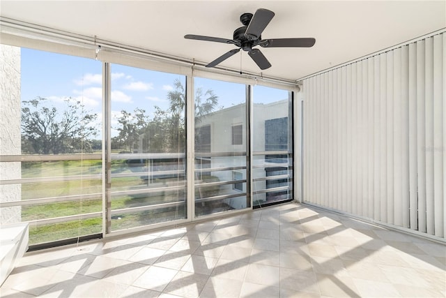 unfurnished sunroom featuring ceiling fan