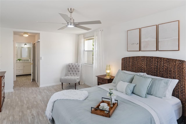 bedroom with connected bathroom, light hardwood / wood-style flooring, and ceiling fan