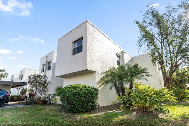 view of property exterior featuring a lawn