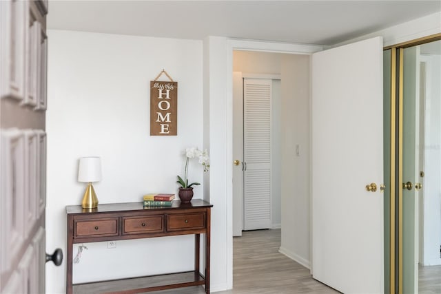 hallway with light hardwood / wood-style floors