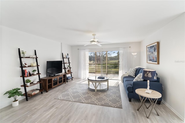 living room featuring light hardwood / wood-style floors and ceiling fan