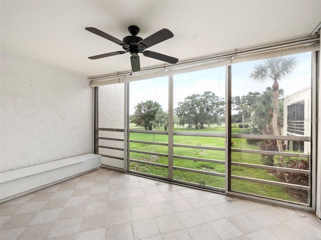 unfurnished sunroom with plenty of natural light and ceiling fan