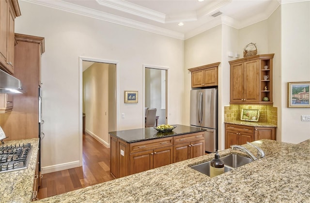 kitchen with sink, crown molding, decorative backsplash, light stone countertops, and stainless steel appliances