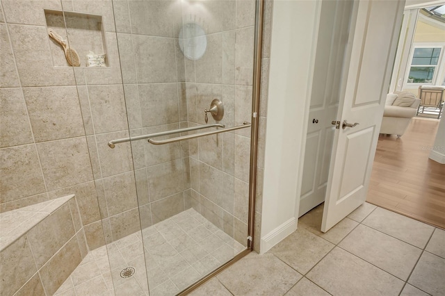 bathroom with tile patterned floors and walk in shower